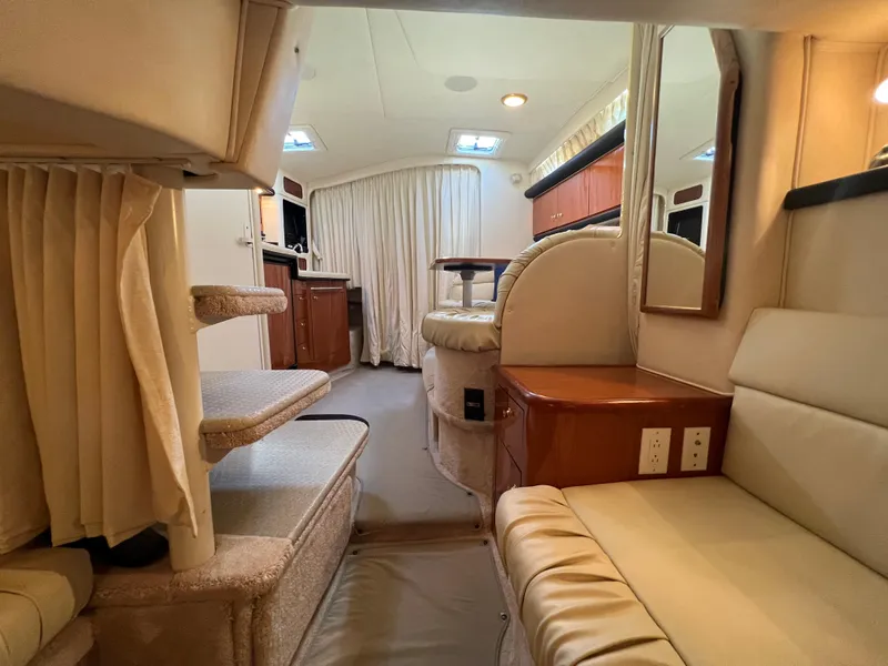 Slide: The Image of Interior of 2000 Sea Ray 34 DA yacht, featuring cozy seating and elegant design. - 26