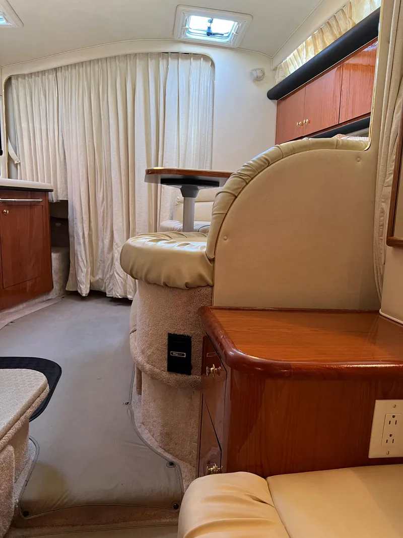 Slide: The Image of Interior of 2000 Sea Ray 34 DA yacht with elegant seating and wood finishes. - 27