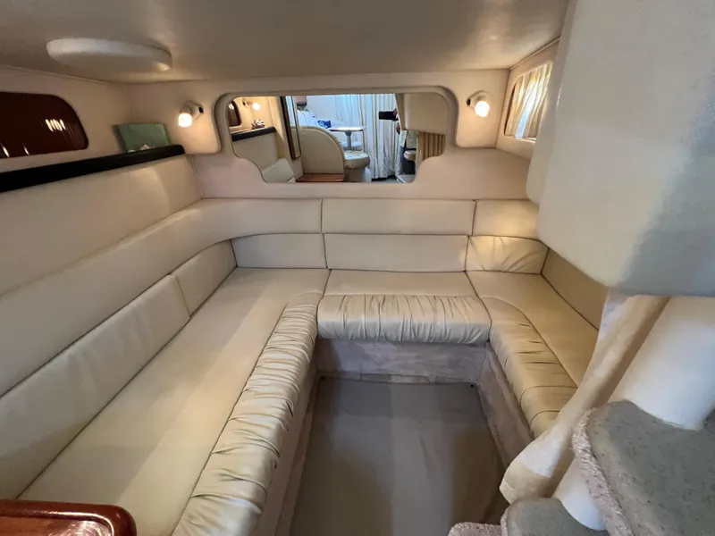 Slide: The Image of Interior of 2000 Sea Ray 34 DA yacht with beige seating and cozy lighting. - 31