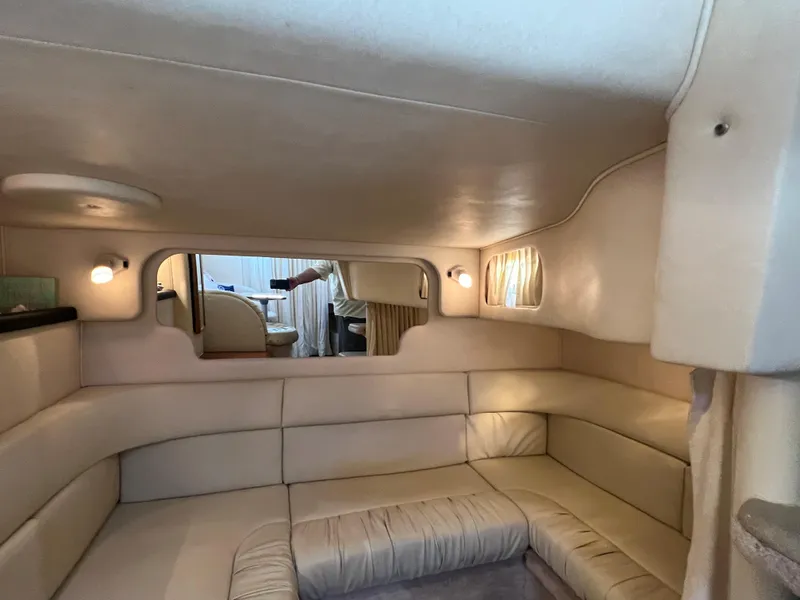 Slide: The Image of Interior of 2000 Sea Ray 34 DA yacht with beige seating and ambient lighting. - 32