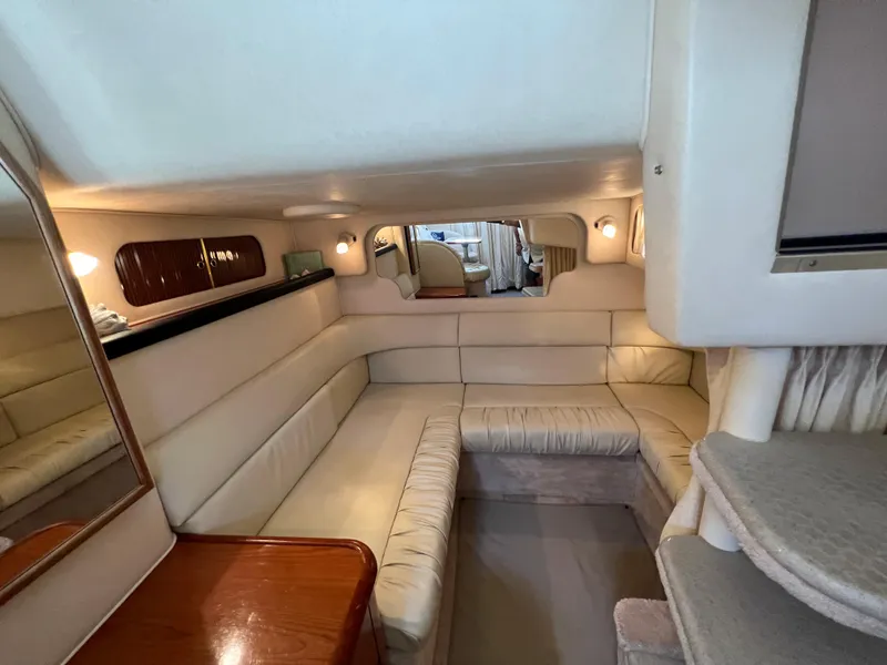 Slide: The Image of Interior of a 2000 Sea Ray 34 DA yacht with beige seating and wooden accents. - 33