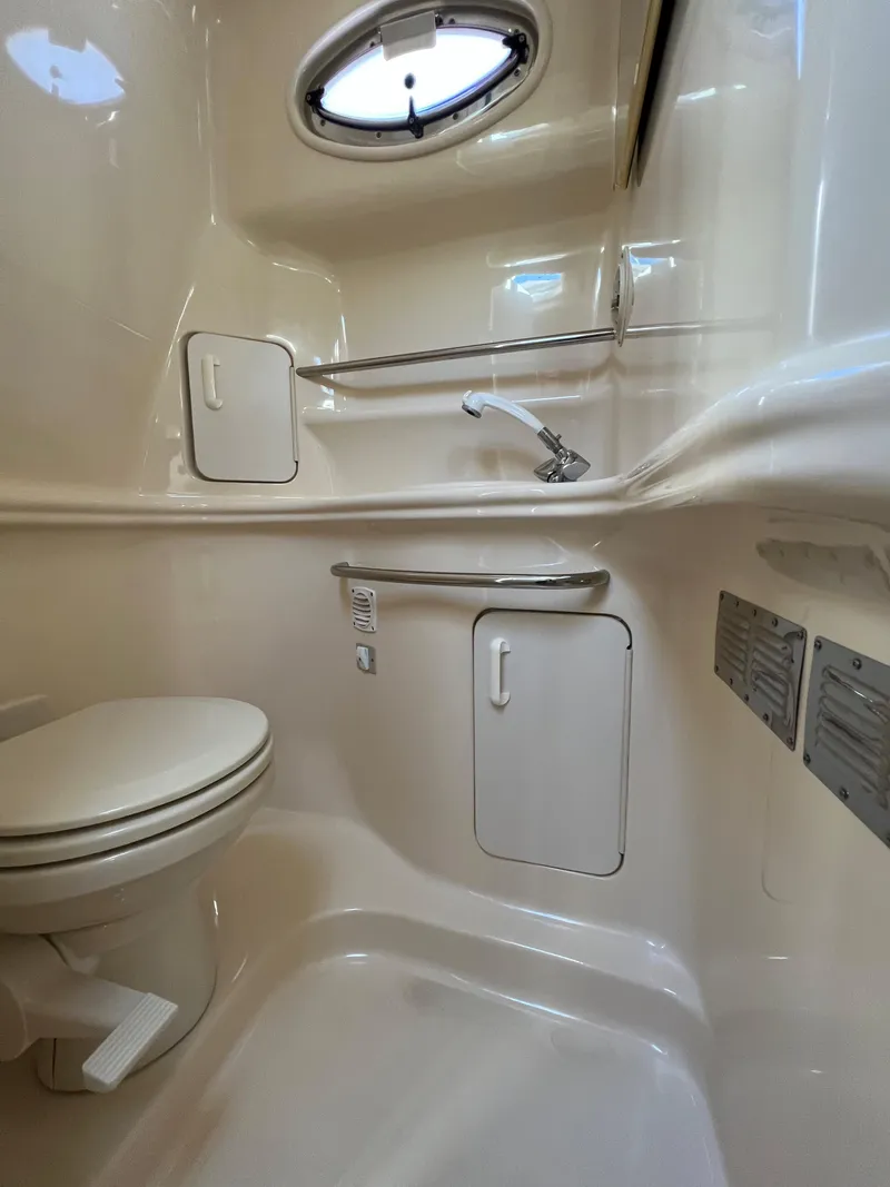 Slide: The Image of 2000 Sea Ray 34 DA boat bathroom with compact design and storage cabinets. - 37