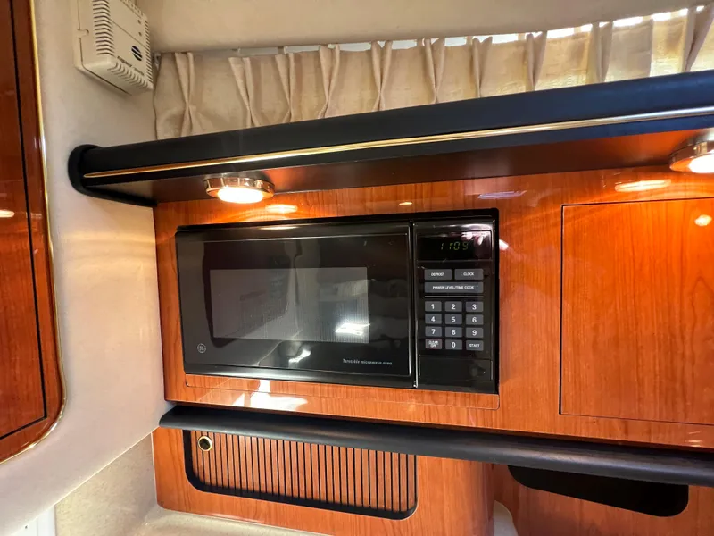 Slide: The Image of 2000 Sea Ray 34 DA yacht interior with microwave and wood cabinetry. - 40