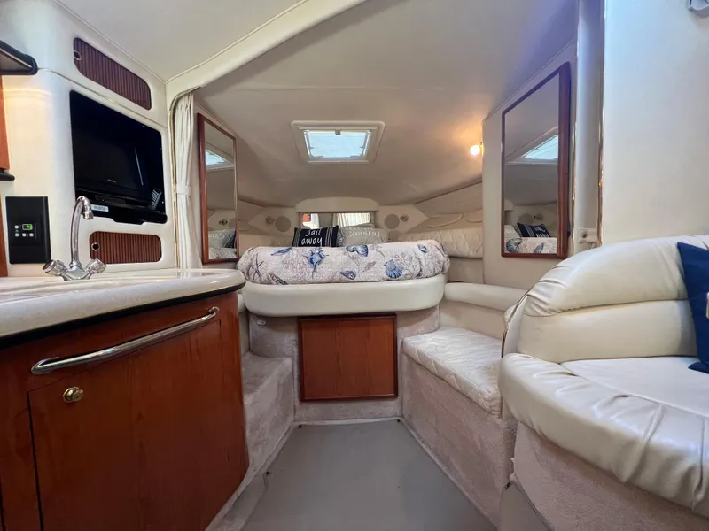 Slide: The Image of Interior of 2000 Sea Ray 34 DA yacht with cozy seating and elegant wood finishes. - 42