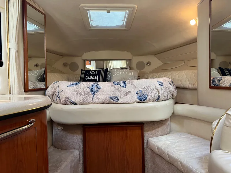 Slide: The Image of Interior of 2000 Sea Ray 34 DA yacht with cozy bed and nautical decor. - 44