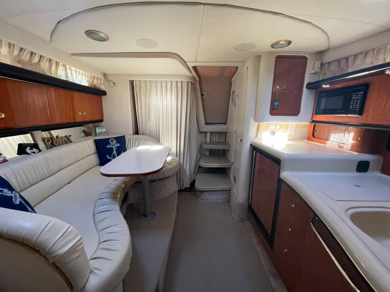 Slide: The Image of Interior of 2000 Sea Ray 34 DA yacht with kitchen and seating area. - 48