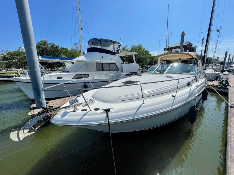 Slide: The Image of 2002 Sea Ray 340 Sundancer docked at a marina on a sunny day. - 10