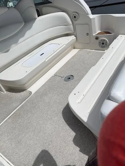Slide: The Image of Interior of a 2002 Sea Ray 340 Sundancer boat with white seating and carpeted floor. - 12
