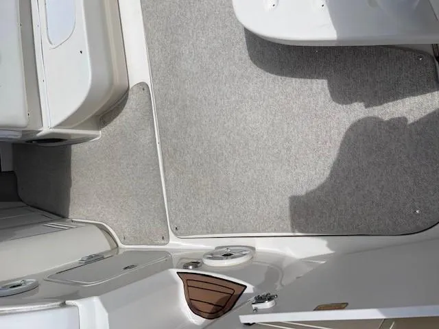 Slide: The Image of 2002 Sea Ray 340 Sundancer boat interior with carpeted flooring and seating area. - 13