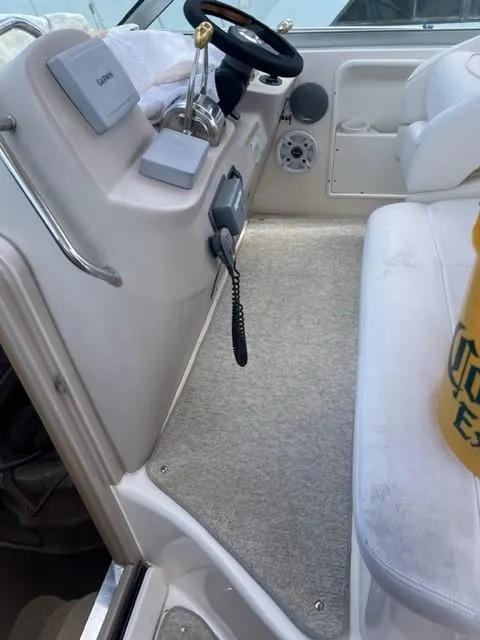 Slide: The Image of Interior helm of a 2002 Sea Ray 340 Sundancer boat with steering wheel and controls. - 14
