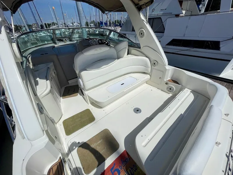 Slide: The Image of 2002 Sea Ray 340 Sundancer boat interior with white seating and helm. - 15