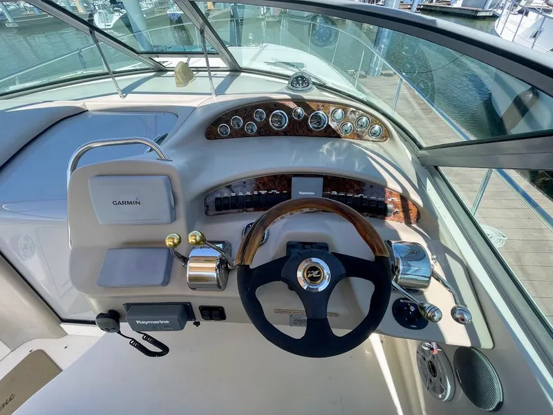 Slide: The Image of 2002 Sea Ray 340 Sundancer helm with Garmin navigation and wood-accented steering wheel. - 18