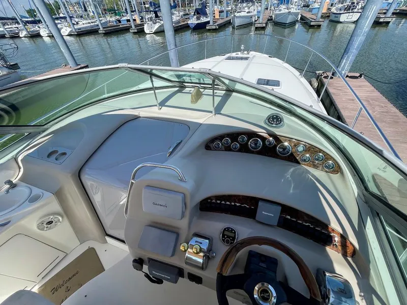 Slide: The Image of 2002 Sea Ray 340 Sundancer boat dashboard and controls at marina. - 20