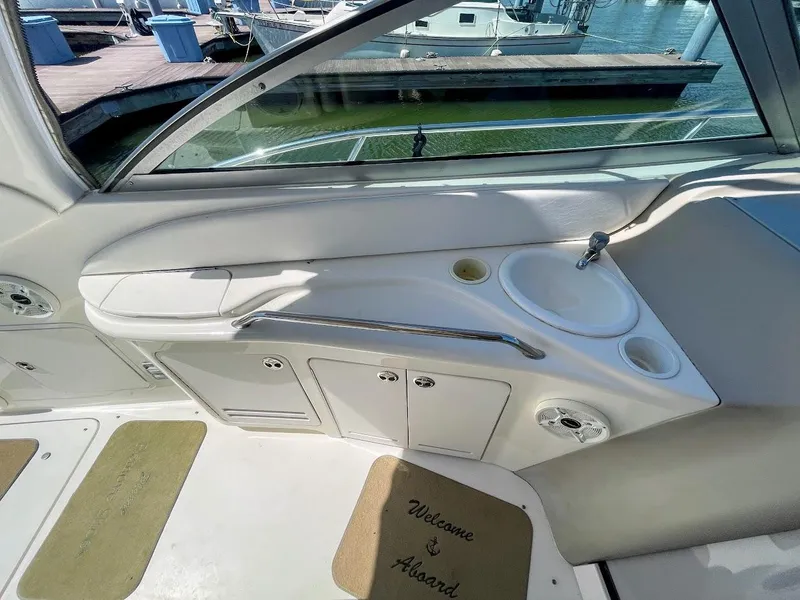 Slide: The Image of 2002 Sea Ray 340 Sundancer boat interior with sink and storage compartments. - 21