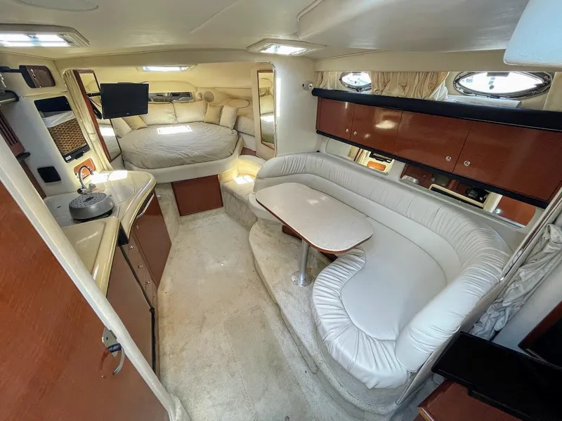 Slide: The Image of 2002 Sea Ray 340 Sundancer interior with cozy seating and sleeping area. - 26