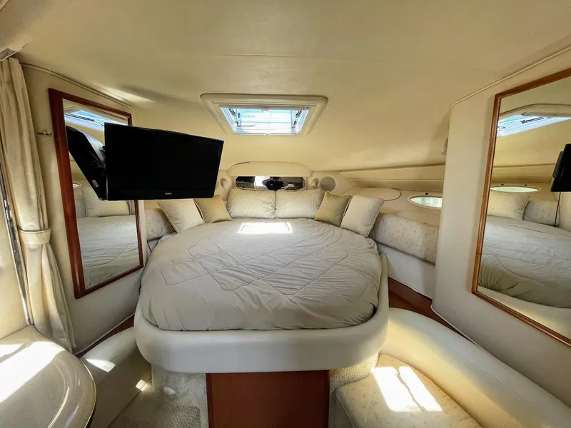 Slide: The Image of Luxurious 2002 Sea Ray 340 Sundancer cabin with a cozy bed and TV. - 29