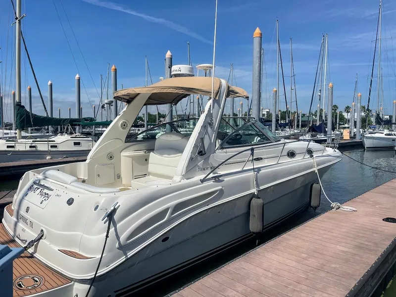 Slide: The Image of 2002 Sea Ray 340 Sundancer docked at marina with blue sky background. - 3