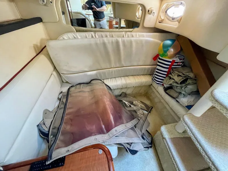 Slide: The Image of Interior of 2002 Sea Ray 340 Sundancer with seating area and accessories. - 31