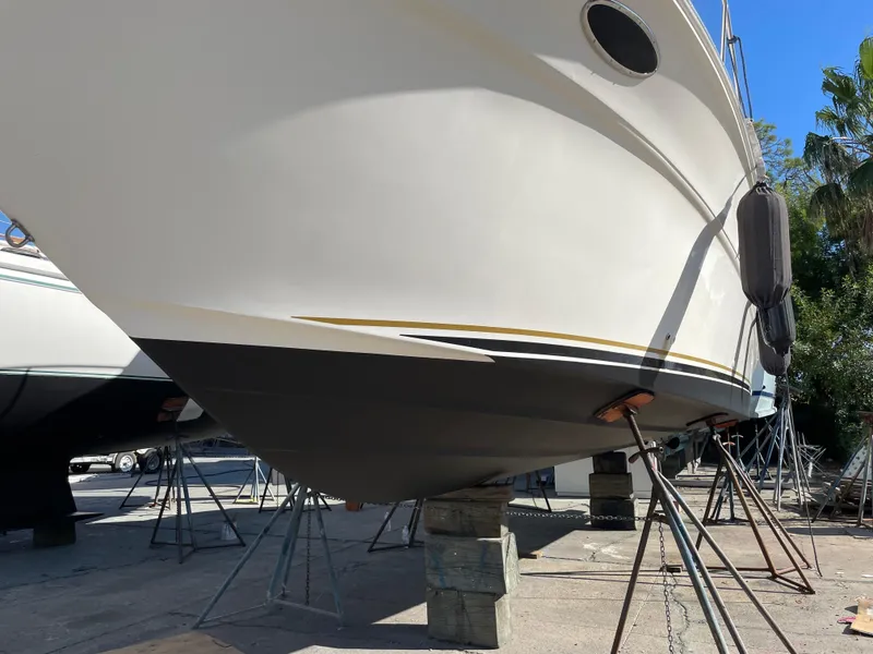 Slide: The Image of 2002 Sea Ray 340 Sundancer yacht on dry dock, supported by stands. - 36