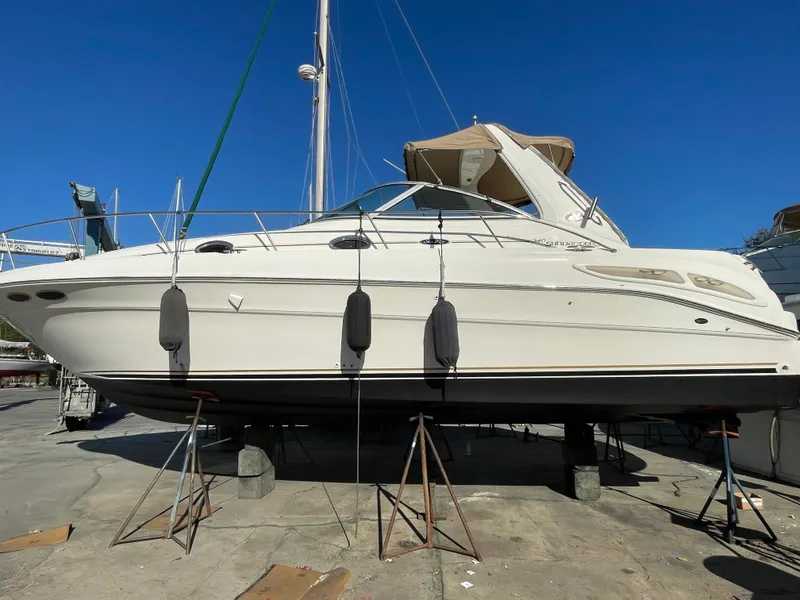 Slide: The Image of 2002 Sea Ray 340 Sundancer yacht on dry dock under clear blue sky. - 37