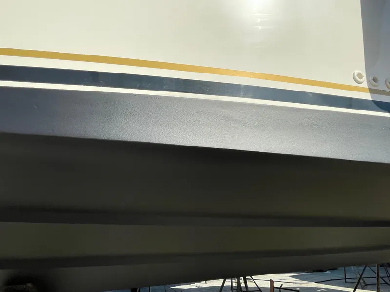 Slide: The Image of Close-up of 2002 Sea Ray 340 Sundancer boat hull with stripes. - 38