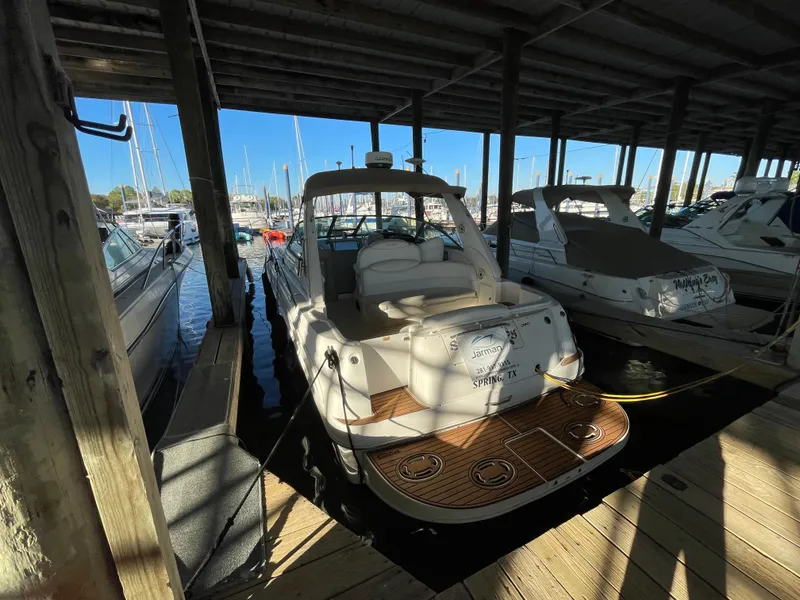 Slide: The Image of 2002 Sea Ray 340 Sundancer docked in a marina under a covered slip. - 41