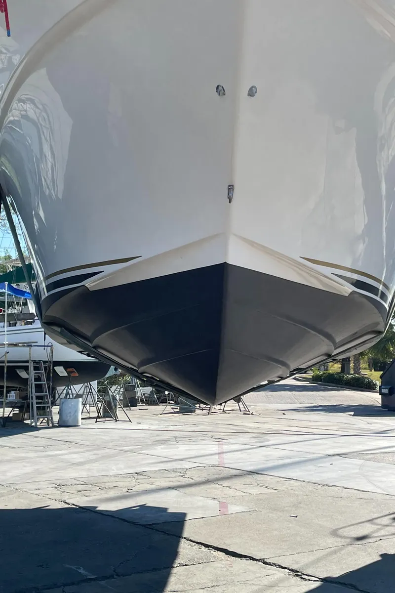 Slide: The Image of 2002 Sea Ray 340 Sundancer boat hull in dry dock, front view. - 42