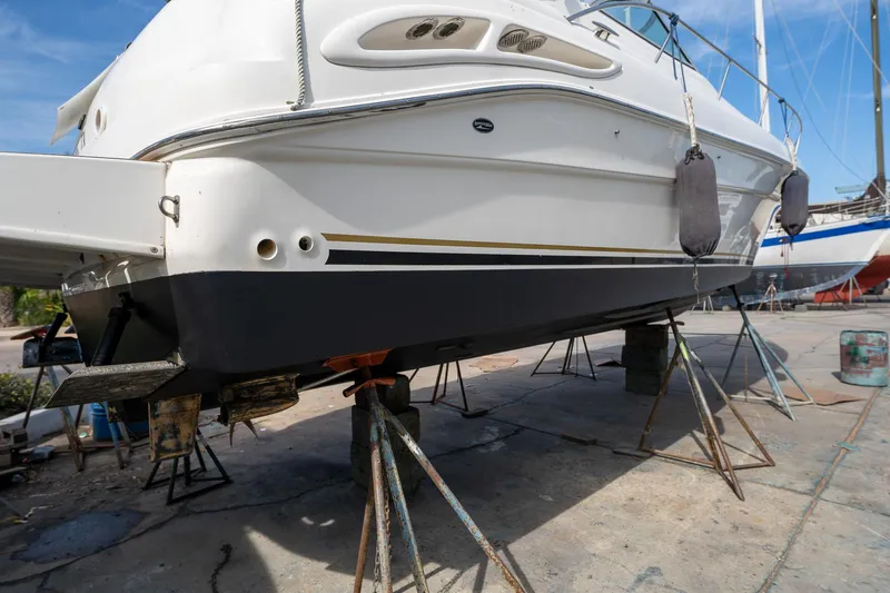 Slide: The Image of 2002 Sea Ray 340 Sundancer yacht on dry dock for maintenance. - 47