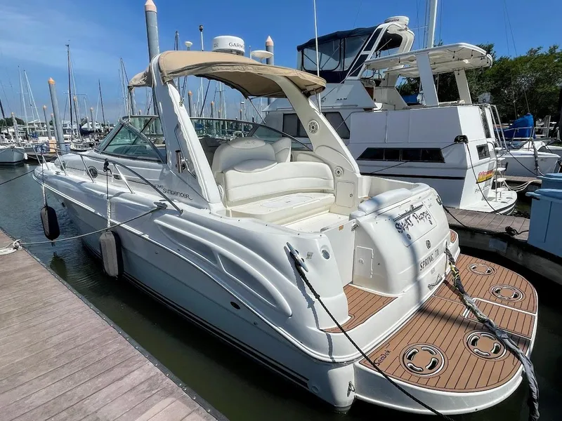 Slide: The Image of 2002 Sea Ray 340 Sundancer docked at marina, rear view. - 5