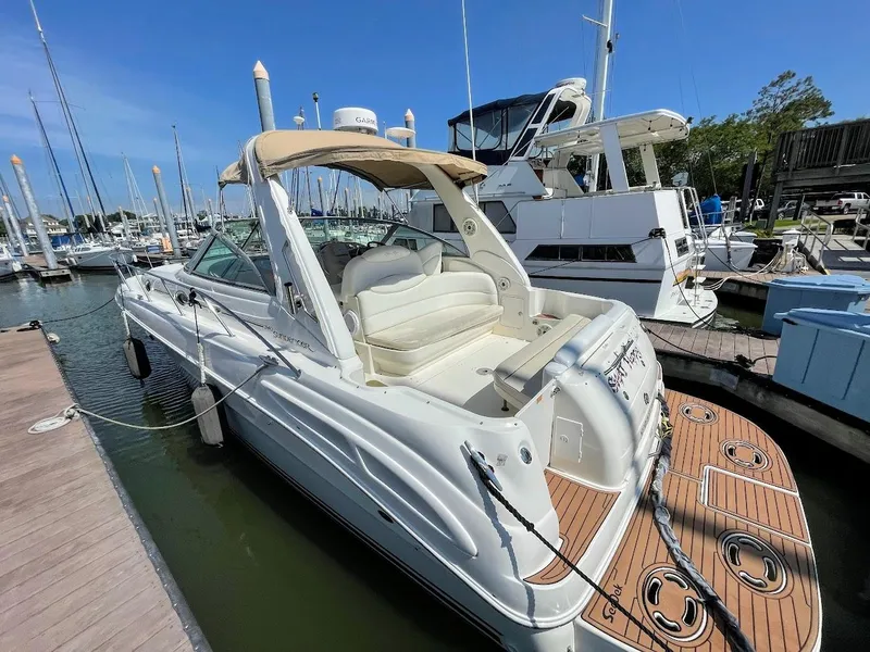 Slide: The Image of 2002 Sea Ray 340 Sundancer docked at a marina on a sunny day. - 7