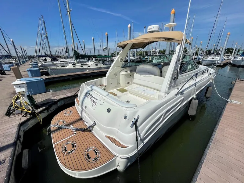 Slide: The Image of 2002 Sea Ray 340 Sundancer docked at a marina on a sunny day. - 8
