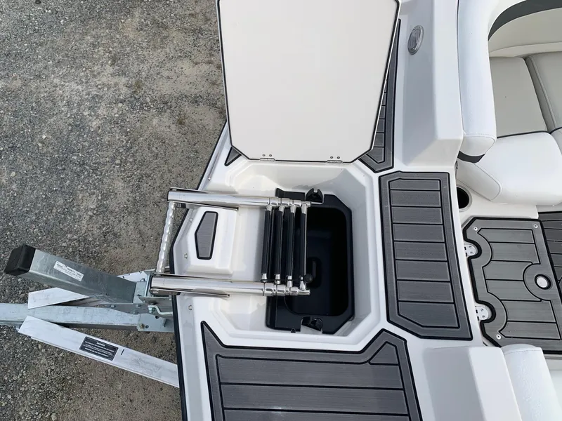 Slide: The Image of 2026 Starcraft SVX 190 boat with open hatch and retractable ladder on deck. - 13