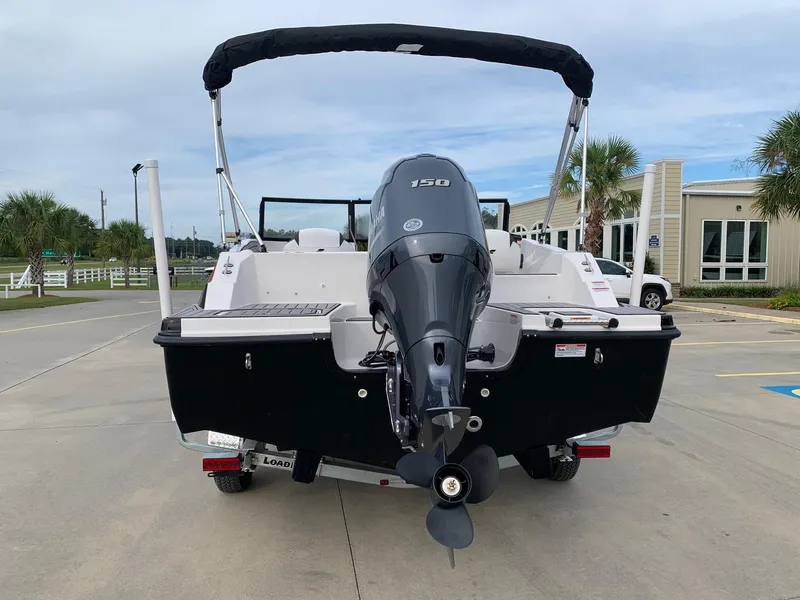 Slide: The Image of 2026 Starcraft SVX 190 boat with outboard motor, parked on a concrete surface. - 3