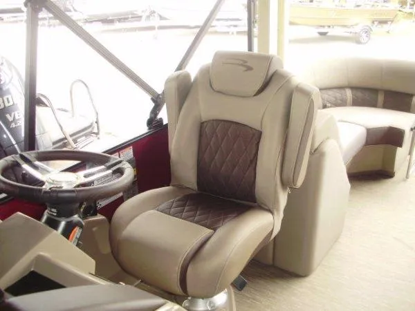 Slide: The Image of 2023 Bennington 22LFB boat interior with luxurious captain's chair and steering wheel. - 2