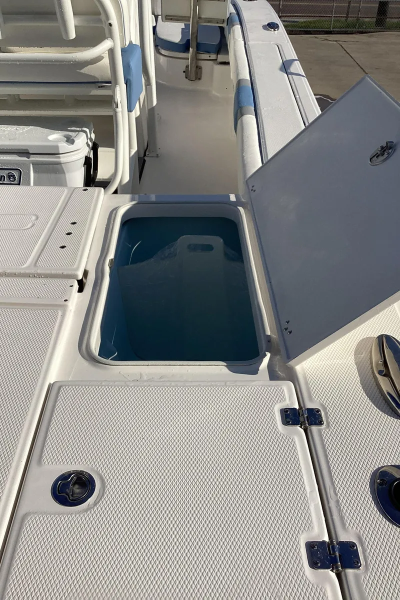Slide: The Image of 2023 Robalo 246 Cayman boat with open storage compartment. - 11