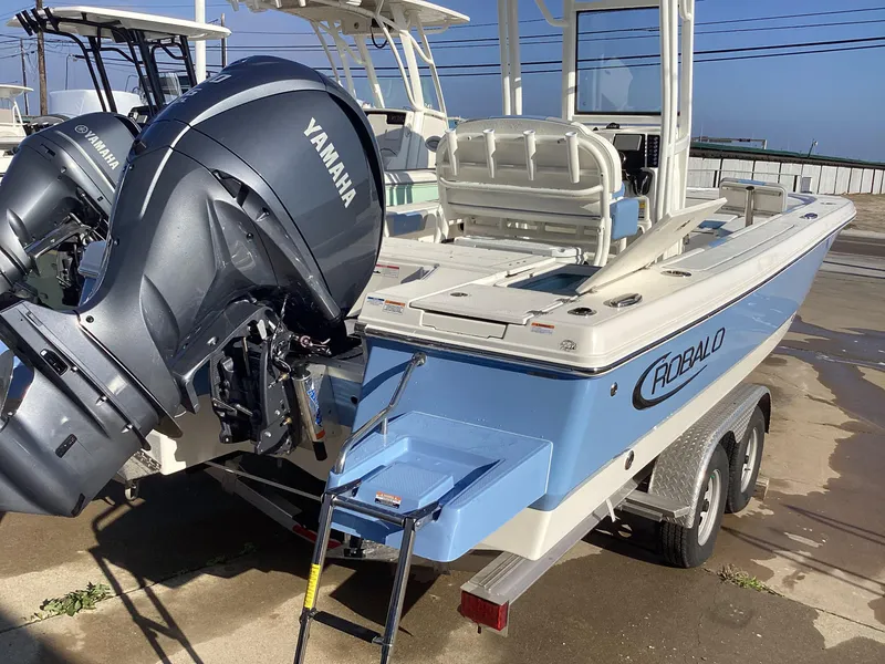 Slide: The Image of 2023 Robalo 246 Cayman boat with Yamaha outboard motor on trailer. - 2