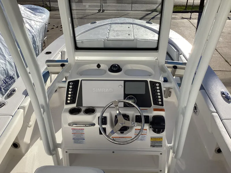 Slide: The Image of 2023 Robalo 246 Cayman boat console with steering wheel and navigation system. - 3