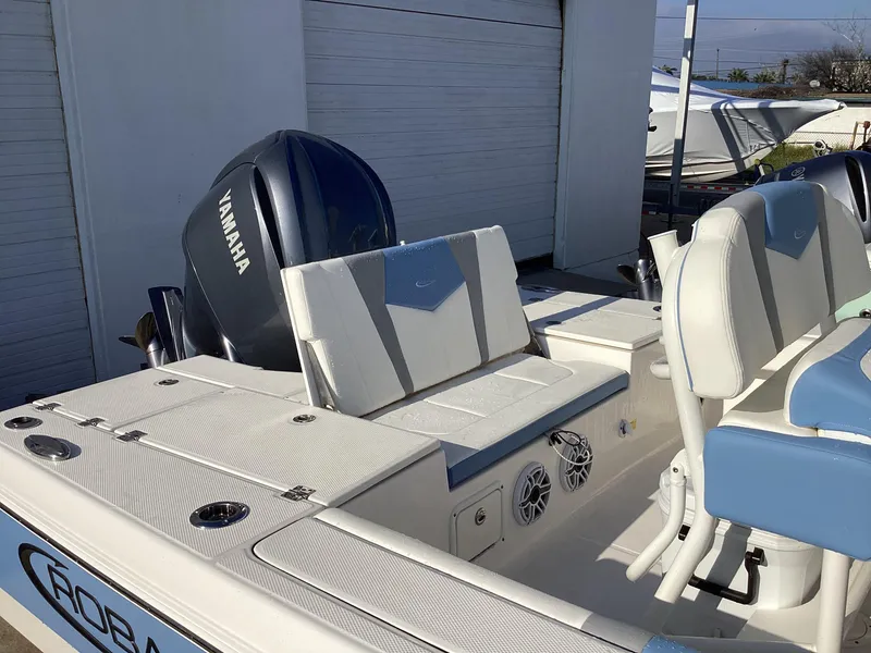 Slide: The Image of 2023 Robalo 246 Cayman boat with Yamaha engine, rear seating, and white and blue interior. - 8