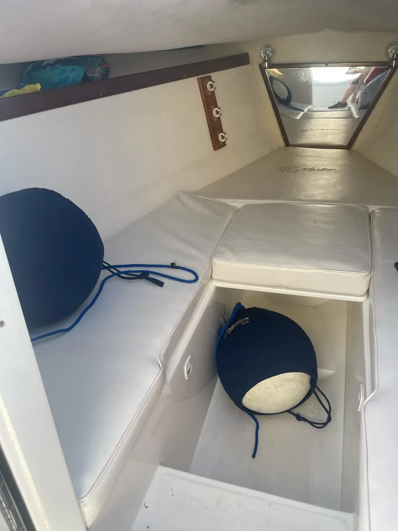 Slide: The Image of Interior of a 2005 Marlago 35 yacht with white cushions. - 6