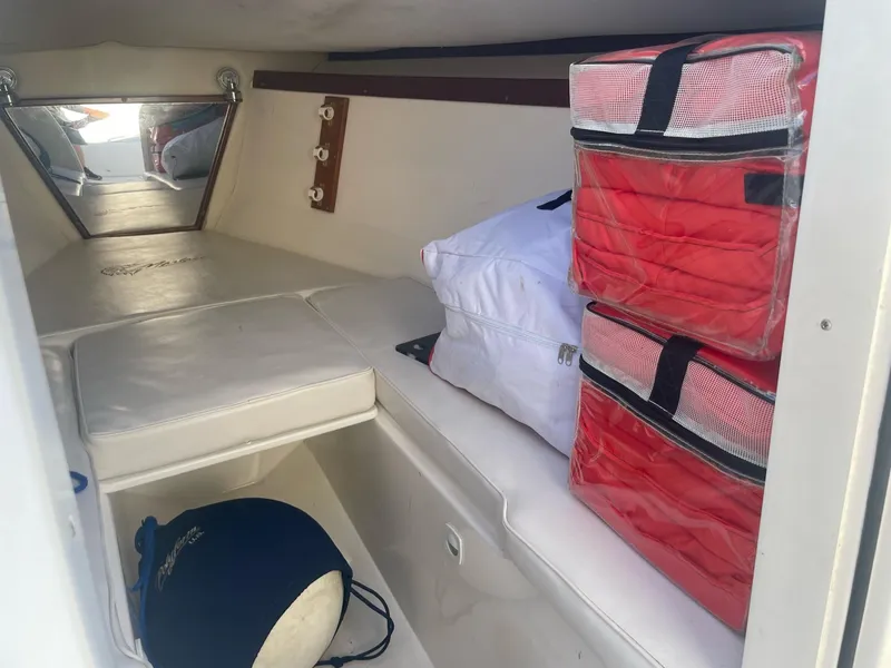 Slide: The Image of Interior of a 2005 Marlago 35 boat with storage and cushions. - 7