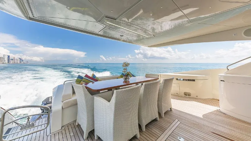 Slide: The Image of Luxurious 2015 Dominator 800 yacht deck with dining area, ocean view, and elegant seating. - 19