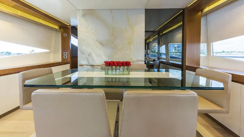 Slide: The Image of Luxurious dining area on 2015 Dominator 800 yacht with glass table and elegant decor. - 24