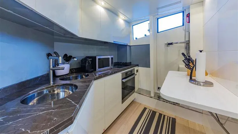 Slide: The Image of Modern yacht kitchen with marble countertops, stainless steel appliances, and ample storage. Dominator 800, 2015. - 26