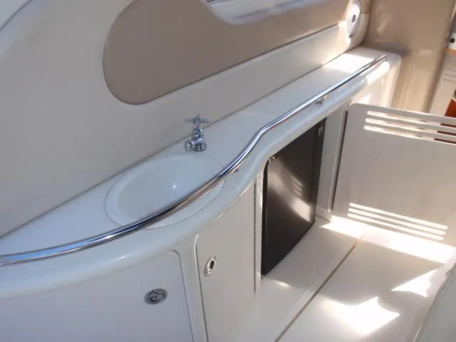 Slide: The Image of 1999 Sea Ray 410 Express Cruiser interior with sink and storage area. - 10