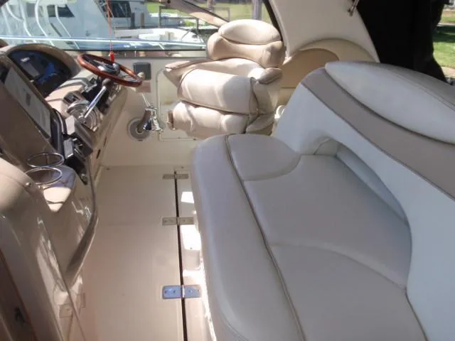 Slide: The Image of 1999 Sea Ray 410 Express Cruiser interior with plush seating and modern dashboard. - 11