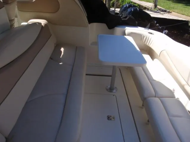 Slide: The Image of 1999 Sea Ray 410 Express Cruiser interior with seating and table. - 13