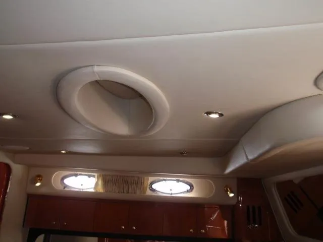 Slide: The Image of Interior ceiling of 1999 Sea Ray 410 Express Cruiser with recessed lighting and portholes. - 17
