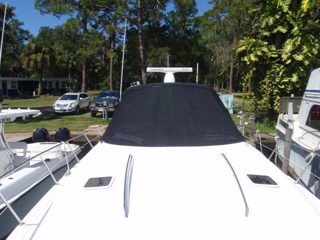 Slide: The Image of 1999 Sea Ray 410 Express Cruiser docked at marina, rear view. - 3