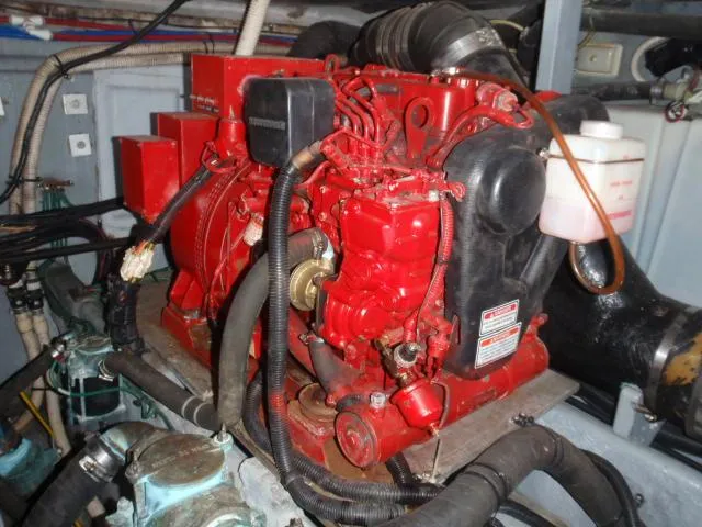 Slide: The Image of Engine compartment of a 1999 Sea Ray 410 Express Cruiser, featuring a red marine engine. - 31