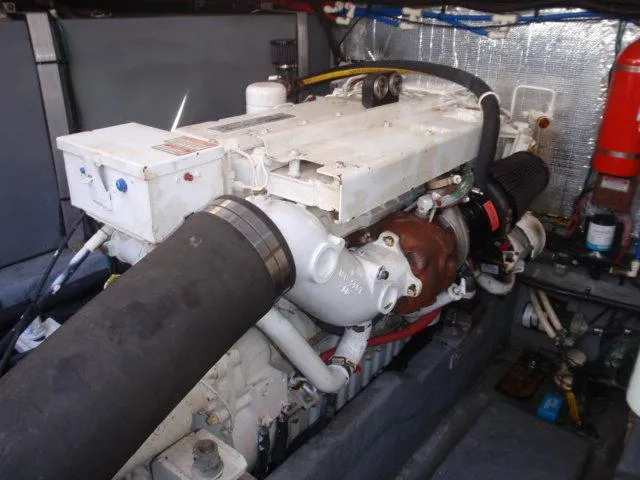 Slide: The Image of Engine compartment of 1999 Sea Ray 410 Express Cruiser, showcasing mechanical components. - 32